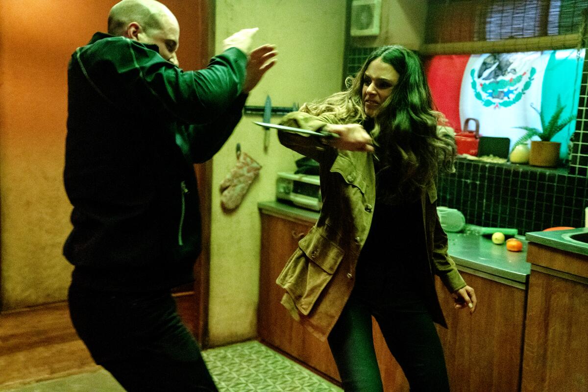 Mia (Jordana Brewster, right) fights a villain in “F9”, co-written and directed by Justin Lin.