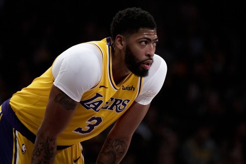 Lakers forward Anthony Davis catches his breath during a break in play earlier this season.