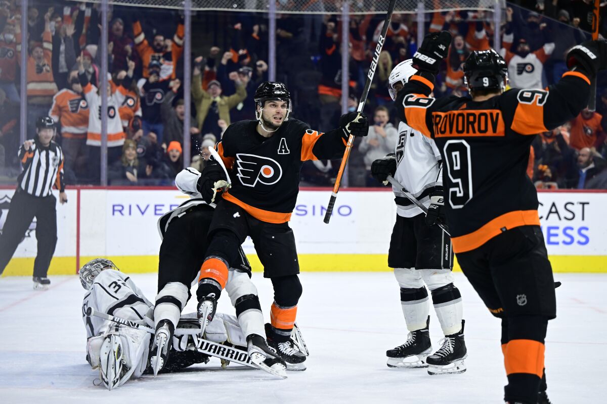 The Flyers' Scott Laughton, center, celebrates after scoring the winning goal in overtime past Kings goalie Jonathan Quick.