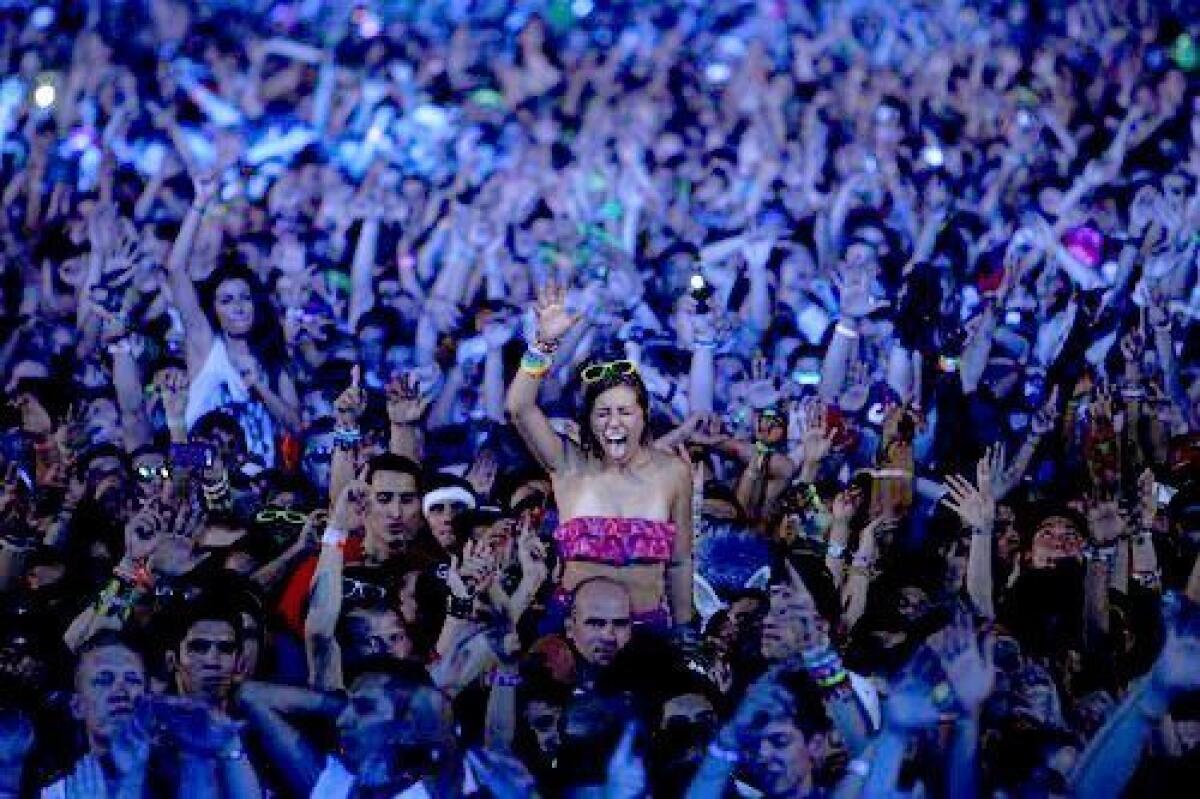 Rave fans dance during a set by DJ David Guetta during the second day of the Electric Daisy Carnival at the Las Vegas Motor Speedway. The EDC is one of the largest electronic music festivals in the world.
