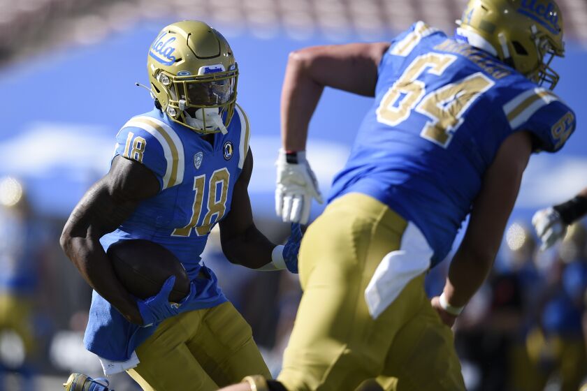 UCLA wide receiver Charles Njoku runs after a catch for a touchdown during the first half of an NCAA college football game against California in Los Angeles, Sunday, Nov. 15, 2020. (AP Photo/Kelvin Kuo)