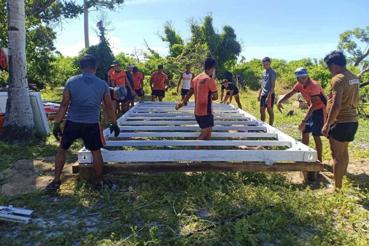 In this photo provided by the Philippine Coast Guard, Coast Guard members construct an outpost at an island in the disputed South China Sea on May 17, 2022. The Philippines has established three coast guard outposts on three islands in the disputed South China Sea to monitor ship movements and promote safety, coast guard officials said Friday, amid increasing maritime tensions with China. (Philippine Coast Guard via AP)