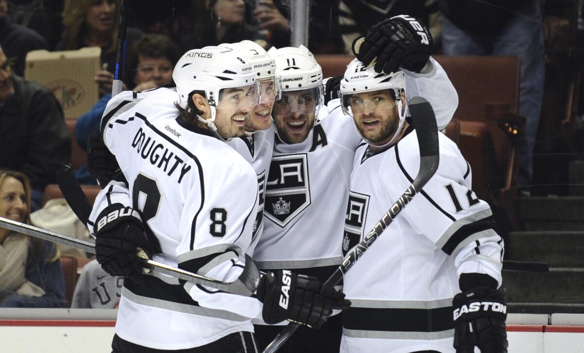 Kings teammates, from left, Drew Doughty, Brayden McNabb, Anze Kopitar and Marian Gaborik celebrate a goal by McNabb in the second period Friday night in Anaheim.