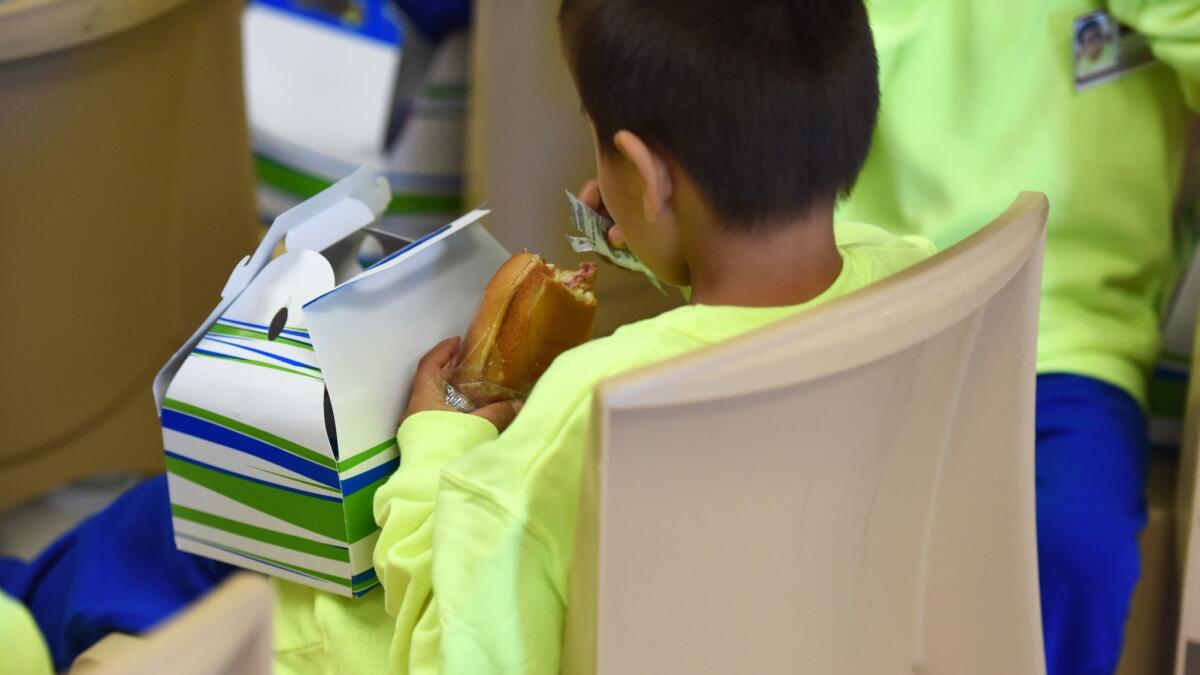 A migrant boy eats at South Texas Family Residential Center in Dilley, Texas on Aug. 9.