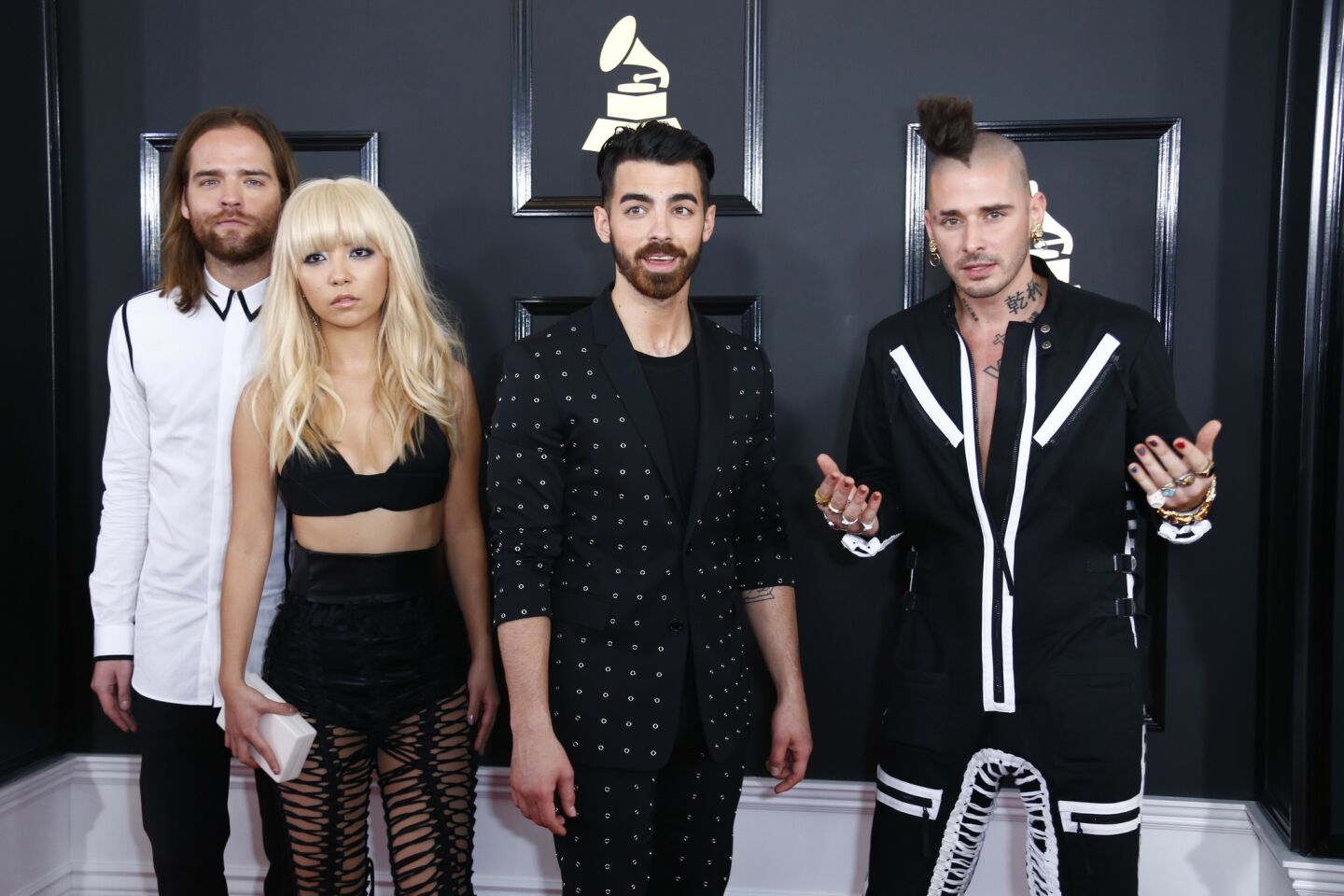 From left, Jack Lawless, JinJoo Lee, Joe Jonas and Cole Whittle of DNCE arrive at the 59th Grammy Awards.
