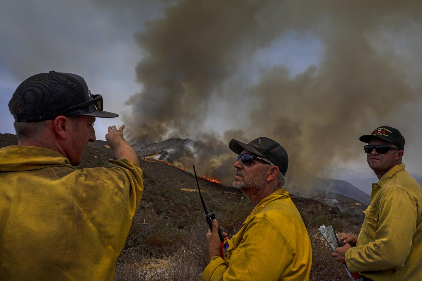 Chief Mark Lamont, center, oversees firefighting operations at North Main Divide along Ortega Highway.