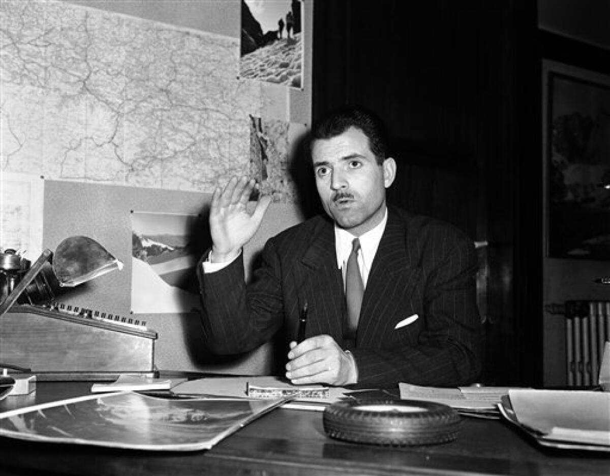 FILE - A March 11, 1950 photo from files showing Maurice Herzog, of Paris, who will lead a French mountain climbing expedition in the Himalayas this spring, talking with reporters as he describes the preparations. French mountaineer Maurice Herzog, the first person to scale the 8,091-meter (26,545-foot) Annapurna peak, has died at the age of 93. Herzog died early Friday, Dec. 14, 2012, said Pierre You, the president of the French Federation of Mountaineering and Climbing. (AP Photo/File)