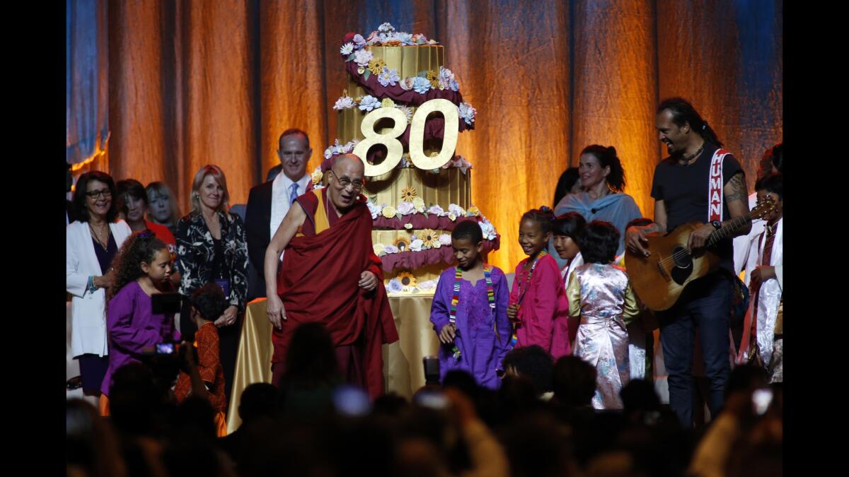 The Dalai Lama acknowledges birthday greetings from well-wishers at the Global Compassion Summit at the Honda Center in Anaheim on July 4. His actual birthday is July 6.