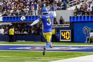 The Rams' Kamren Curl (3) skips into the end zone after returning a fumble 33 yards for a touchdown against the Raiders.