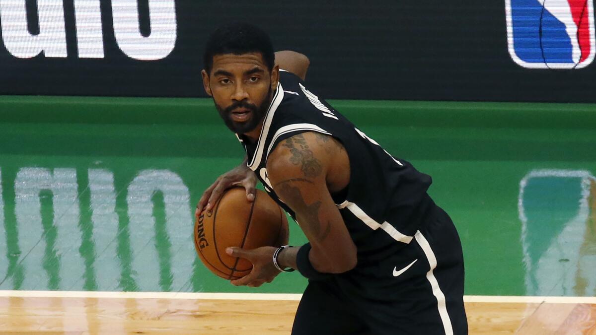 Brooklyn Nets guard Kyrie Irving handles the ball during a game.