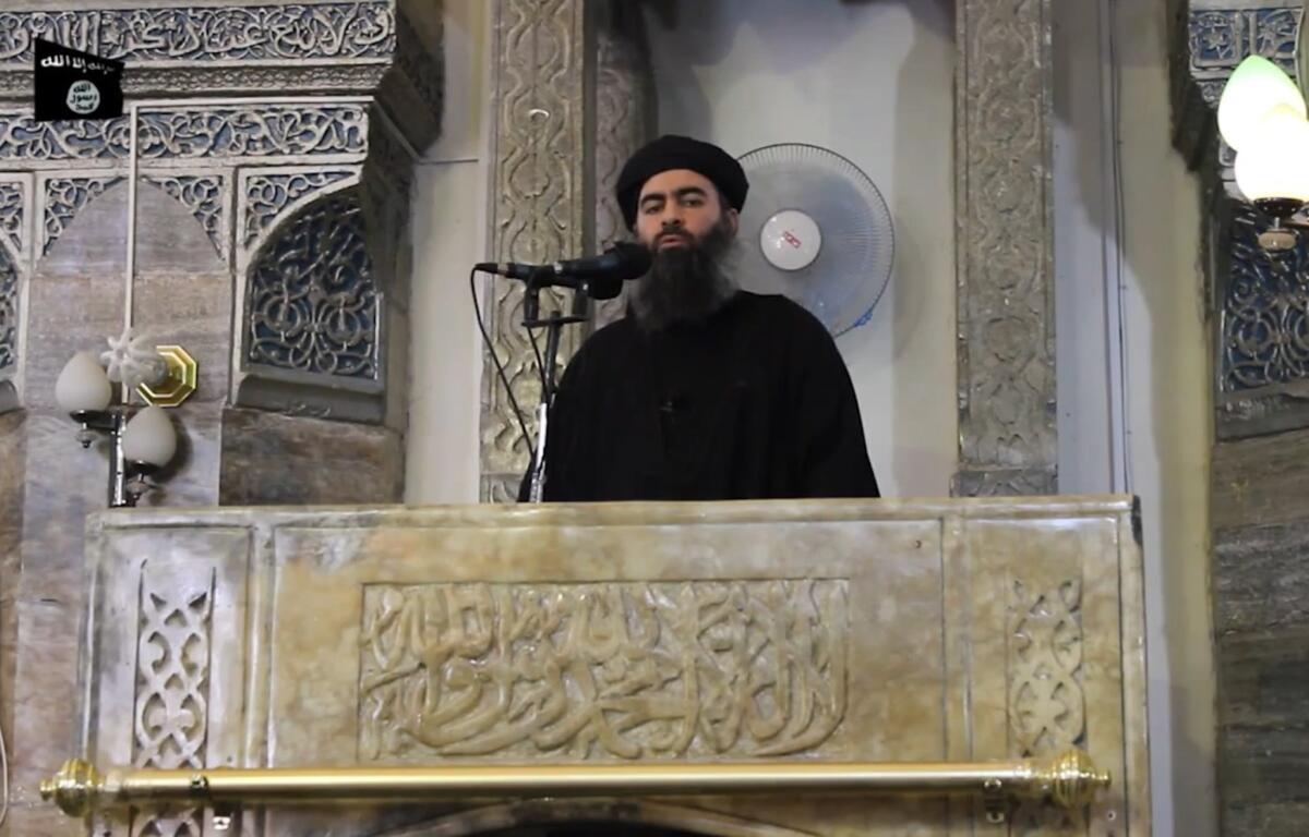 A file image grab taken from a propaganda video released on July 5, 2014, by al-Furqan Media purportedly shows the leader of the Islamic State jihadist group, Abu Bakr Baghdadi, at a mosque in the militant-held northern Iraqi city of Mosul.