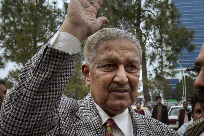 FILE - In this Feb. 26, 2013, file photo, Pakistan's nuclear scientist Abdul Qadeer Khan waves to supporters in Islamabad, Pakistan. Known as the father of Pakistan's nuclear bomb, Khan, died Sunday, Oct. 10, 2021 following a lengthy illness. He was 85. (AP Photo/B.K. Bangash, File)