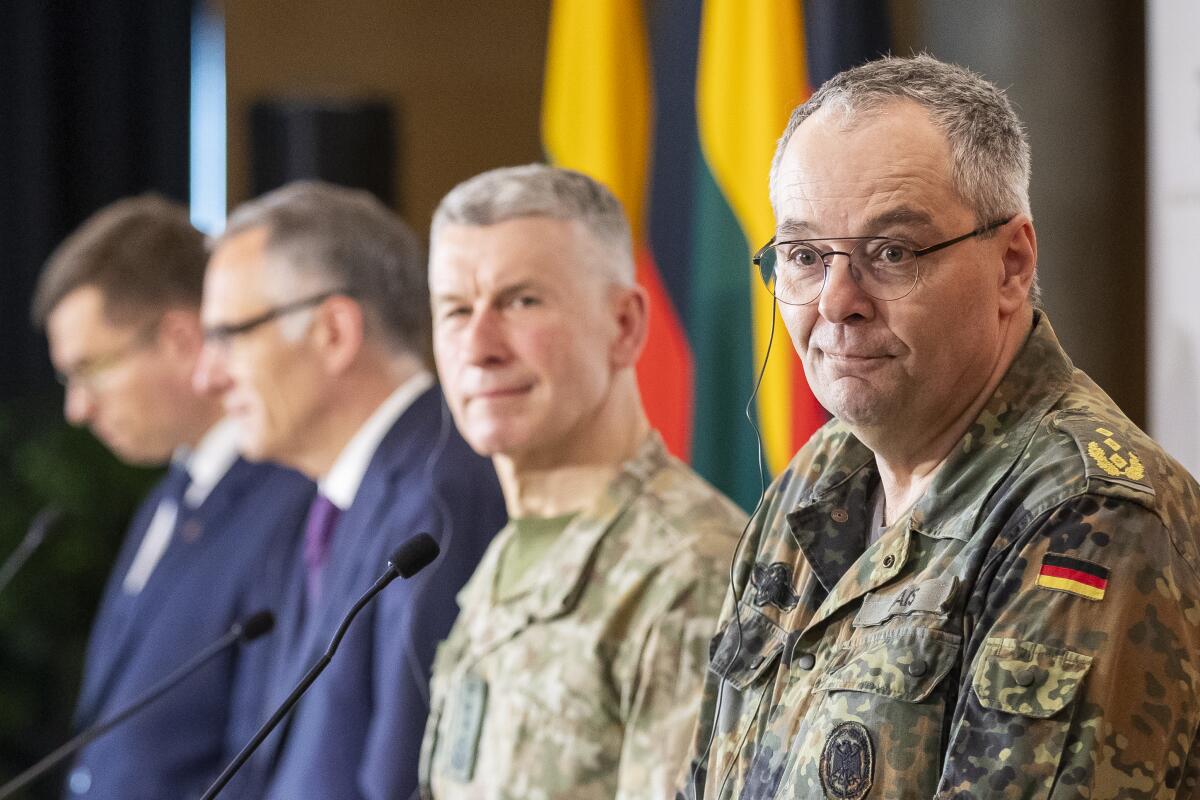 German Army Chief Lt. Gen. Alfons Mais listens to a question during a media joint conference with Lithuanian Chief of Defence Gen. Valdemaras Rupsys and Lithuanian Defense Minister Laurynas Kasciunas as members of the Headquarters initial command element of the Bundeswehr's 45th Brigade Lithuania arrival by plane at a airport in Vilnius, Lithuania, Monday, April 8, 2024. Germany has made a commitment to deploy a heavy brigade with three maneuver battalions and all necessary enablers, including combat support and provision units, to Lithuania. In total, approx. 5 thousand German military and civilian personnel are expected to move to Lithuania with families in stationing the Brigade. (AP Photo/Mindaugas Kulbis)
