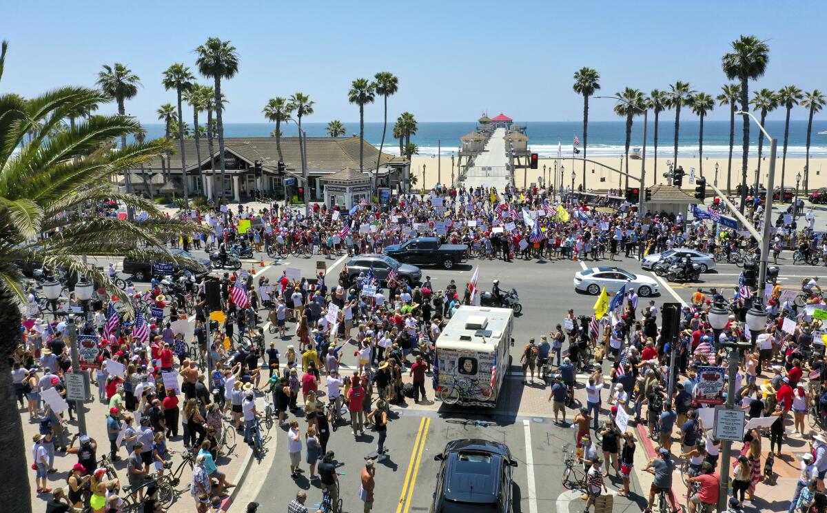 Thousands of protesters rally at the intersection of Main Street and Pacific Coast Highway in Huntington Beach.