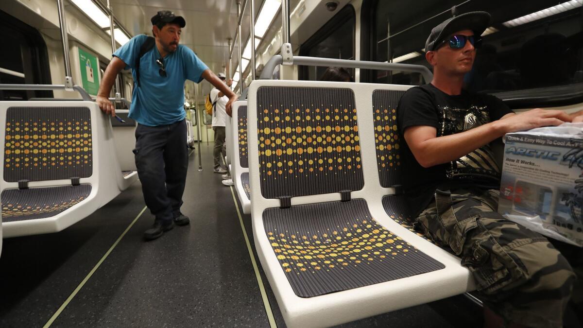 Matt Harrison of Los Angeles tries a new vinyl seat on the Metro Red Line in the San Fernando Valley. The plastic-based fabrics will be installed on all subway cars, Metro says, because they are non-absorbent, cheaper to install and easier to keep clean.