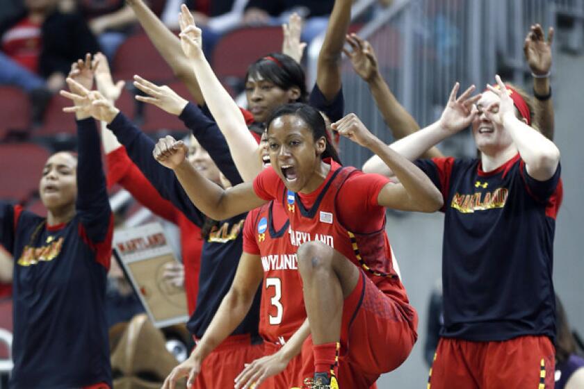 Maryland guard Shatori Walker-Kimbrough (32) and the bench reacts after a three-point basket during the first half of a regional semifinal game against Tennessee on Sunday.