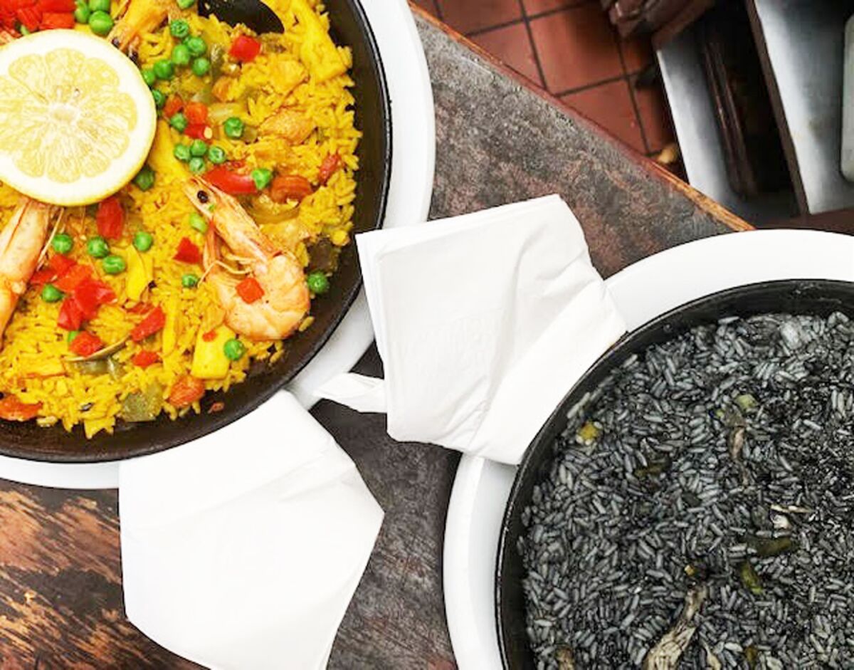 Two paella options — Paella de Mariscos and Arroz negro con sepia.
