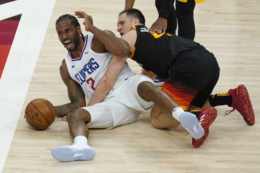 Los Angeles Clippers forward Kawhi Leonard (2) reacts after battling for a loose ball with Utah Jazz forward Bojan Bogdanovic, right, during the second half of Game 2 of a second-round NBA basketball playoff series Thursday, June 10, 2021, in Salt Lake City. (AP Photo/Rick Bowmer)