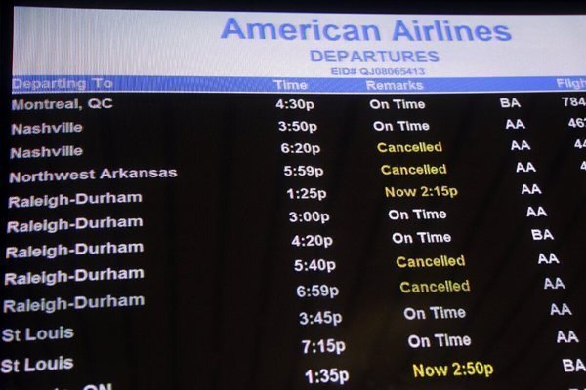 American has shut down operations at eight airports; more than 7,000 flights from all airlines have been canceled as a result of the expected superstorm menacing the East Coast.