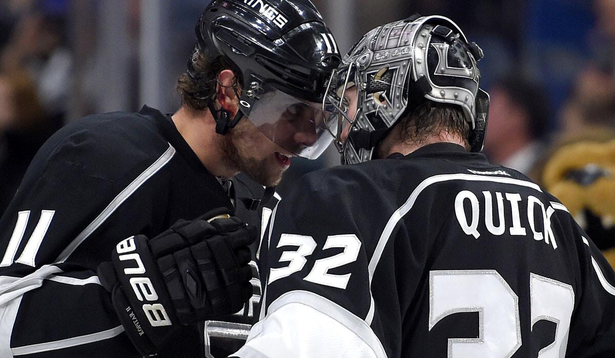 Kings center Anze Kopitar and goalie Jonathan Quick congratulate each other after a 3-1 victory over the Sharks on Saturday night.
