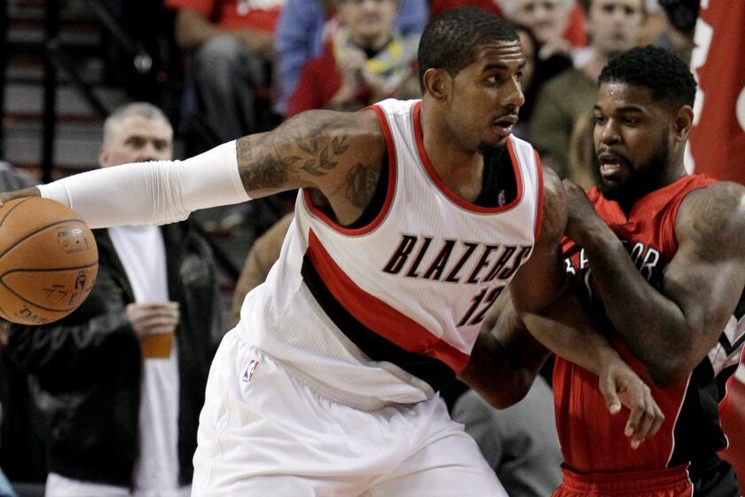 Portland Trail Blazers forward LaMarcus Aldridge, left, tries to work past Toronto Raptors forward Amir Johnson during the Trail Blazers' win on Dec. 30.