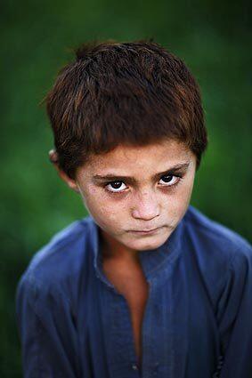 A boy in an Afghan refugee camp on the outskirts of Islamabad, capital of Pakistan. During the Soviet invasion and occupation of Afghanistan, from 1979 to 1989, more than 3 million Afghan refugees fled to Pakistan, according to government statistics. Thousands of them, some born here, still live in these camps without electricity, running water or other basic services.