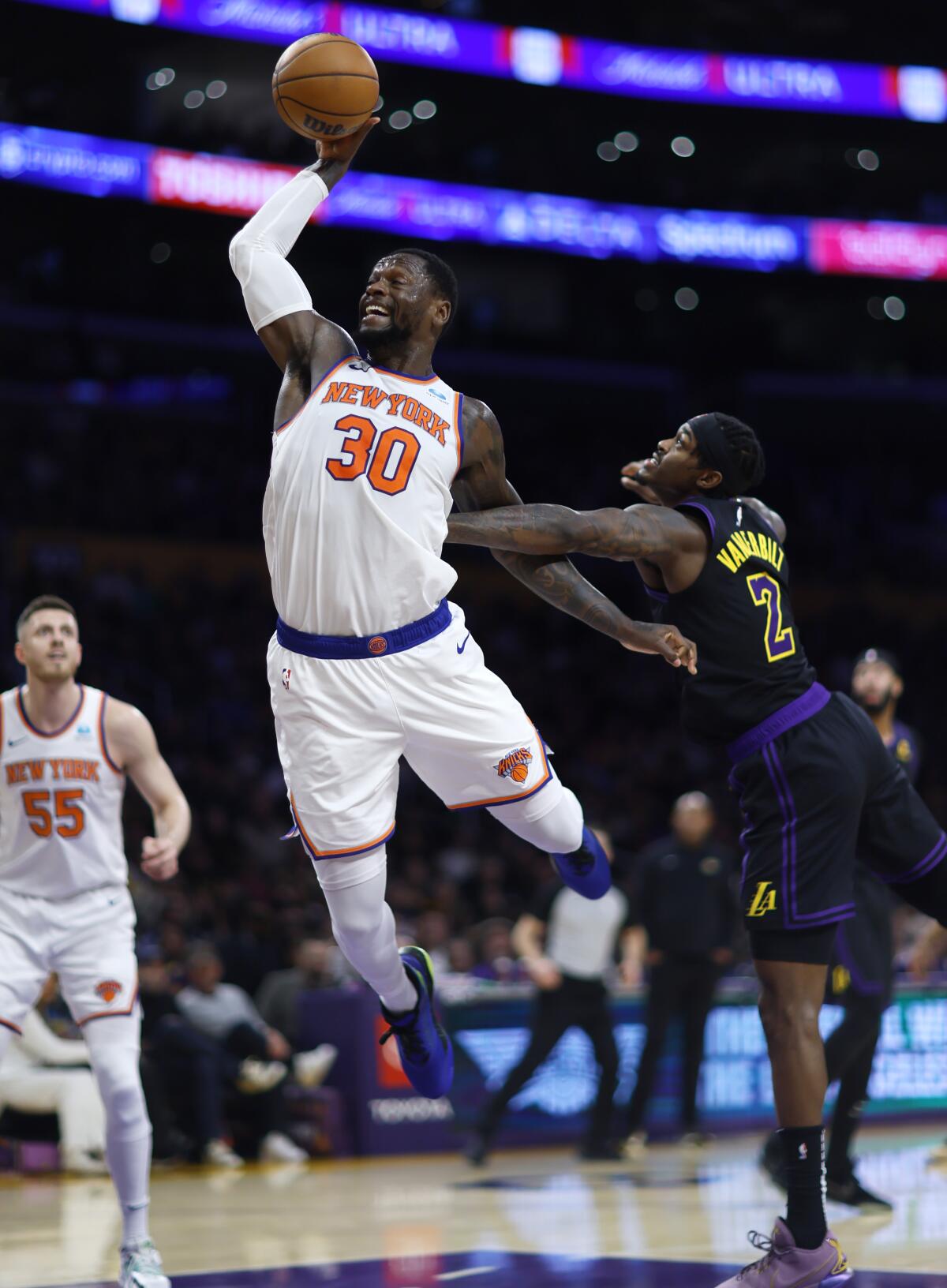 New York Knicks forward Julius Randle is fouled by Lakers forward Jarred Vanderbilt during the first half.