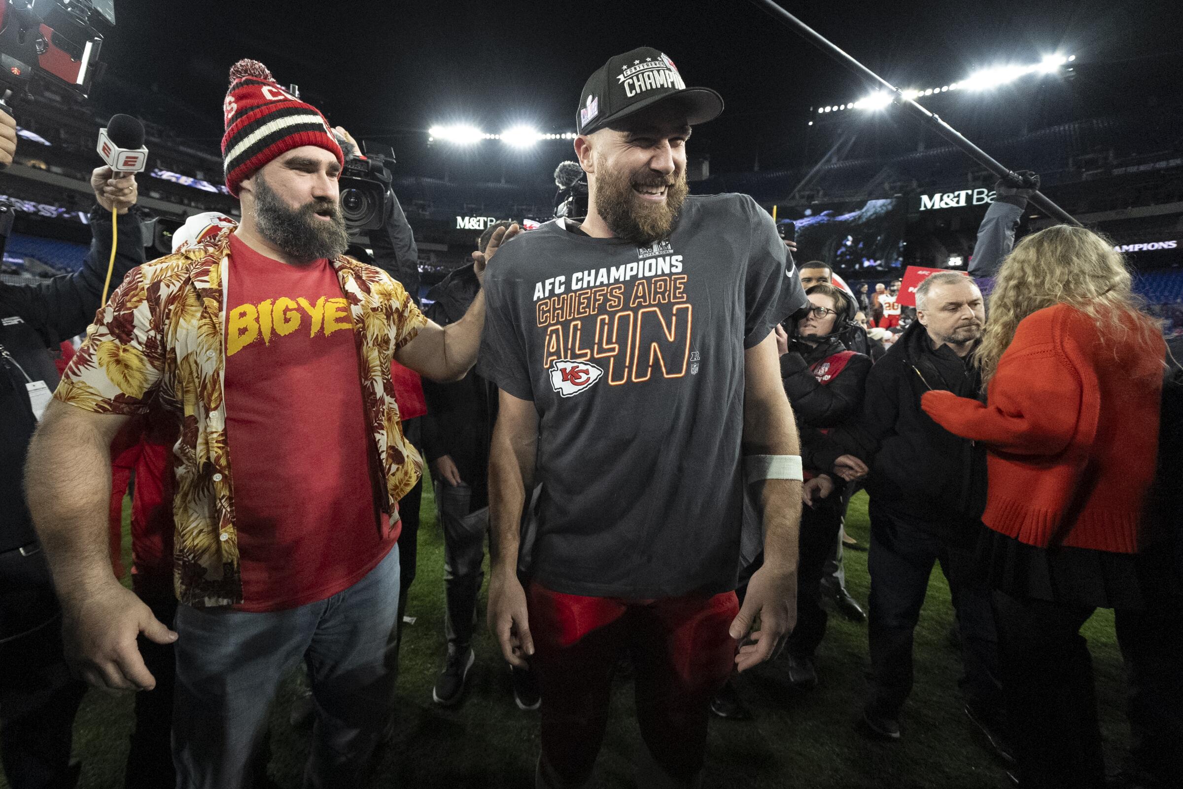 Chiefs tight end Travis Kelce (center) meets with his brother Jason following the AFC championship game.