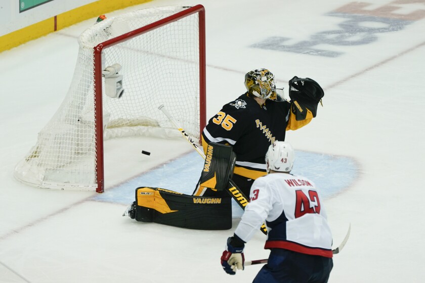 Washington Capitals' Tom Wilson (43) scores on Pittsburgh Penguins goaltender Tristan Jarry (35) during the third period of an NHL hockey game, Saturday, April 9, 2022, in Pittsburgh. The Capitals won 6-3. (AP Photo/Keith Srakocic)