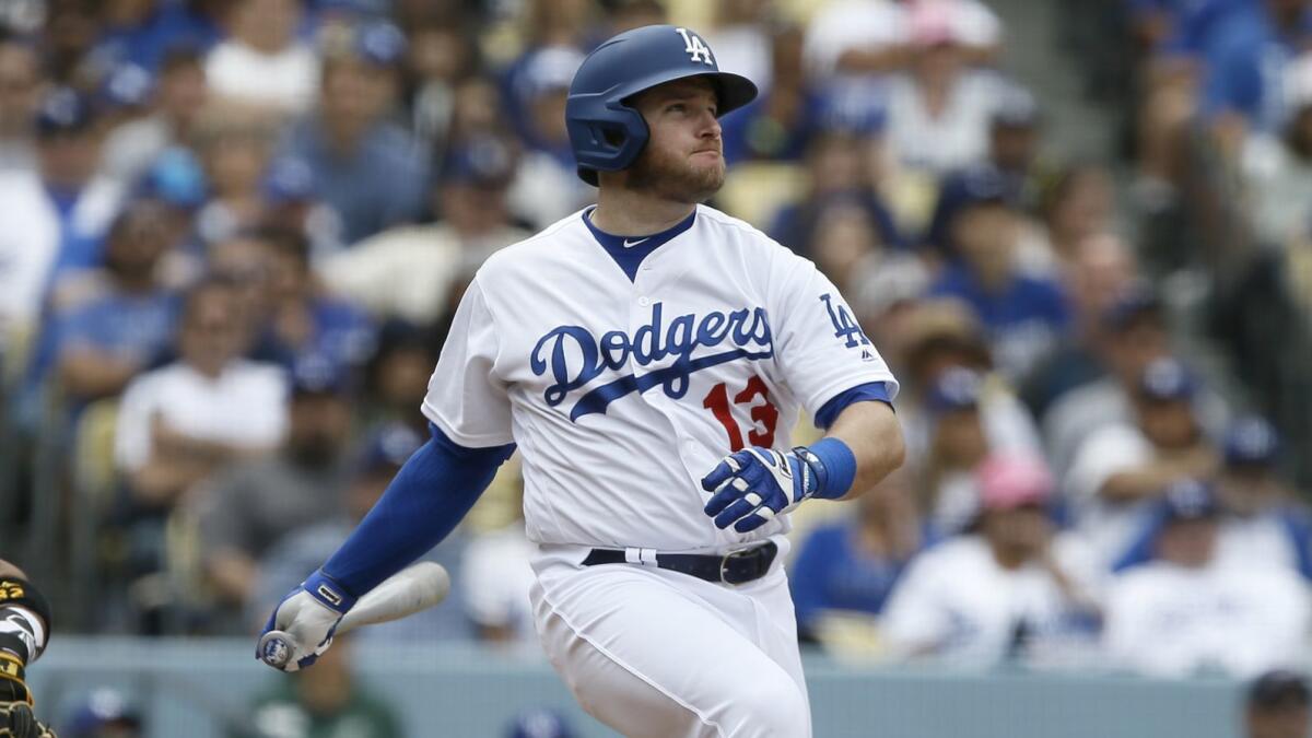 Max Muncy hits a run-scoring single during the fourth inning of the Dodgers' 7-6 victory over the Pittsburgh Pirates on Sunday.