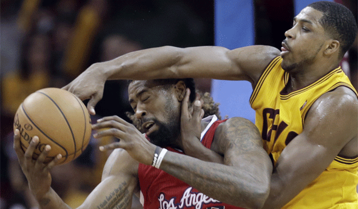 DeAndre Jordan is pressured by the Cavaliers' Tristan Thompson during the Clippers' 88-82 loss Saturday in Cleveland.