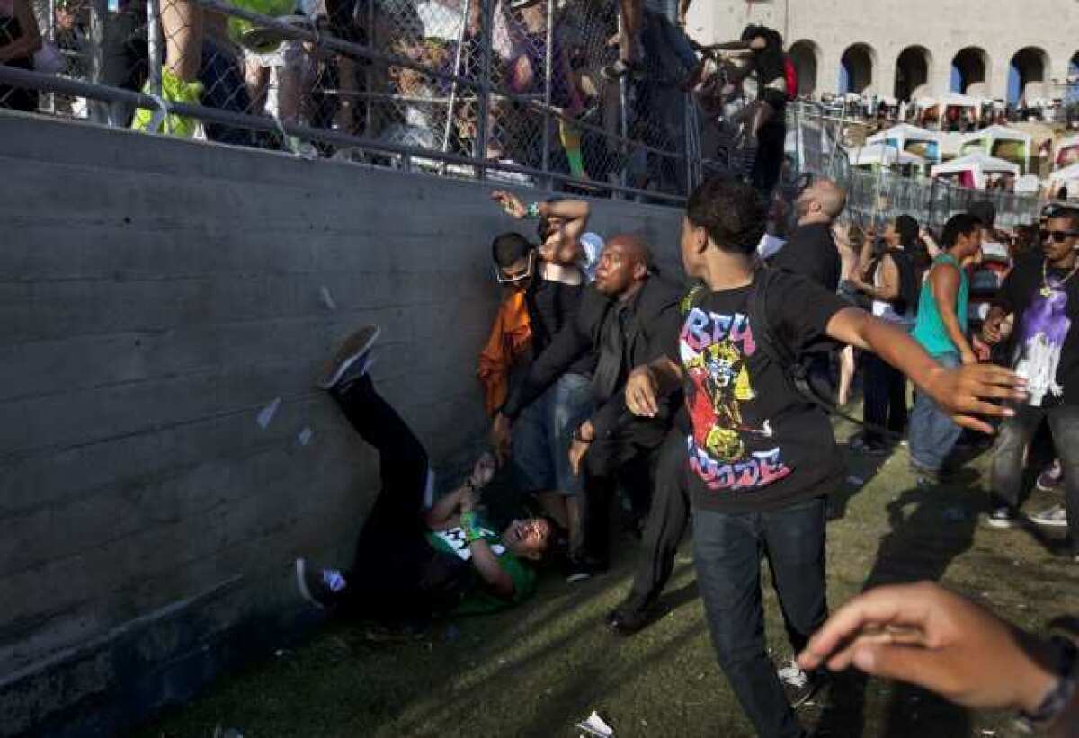 Rave attendees rush the fence at the Electric Daisy Carnival at the Los Angeles Memorial Coliseum.