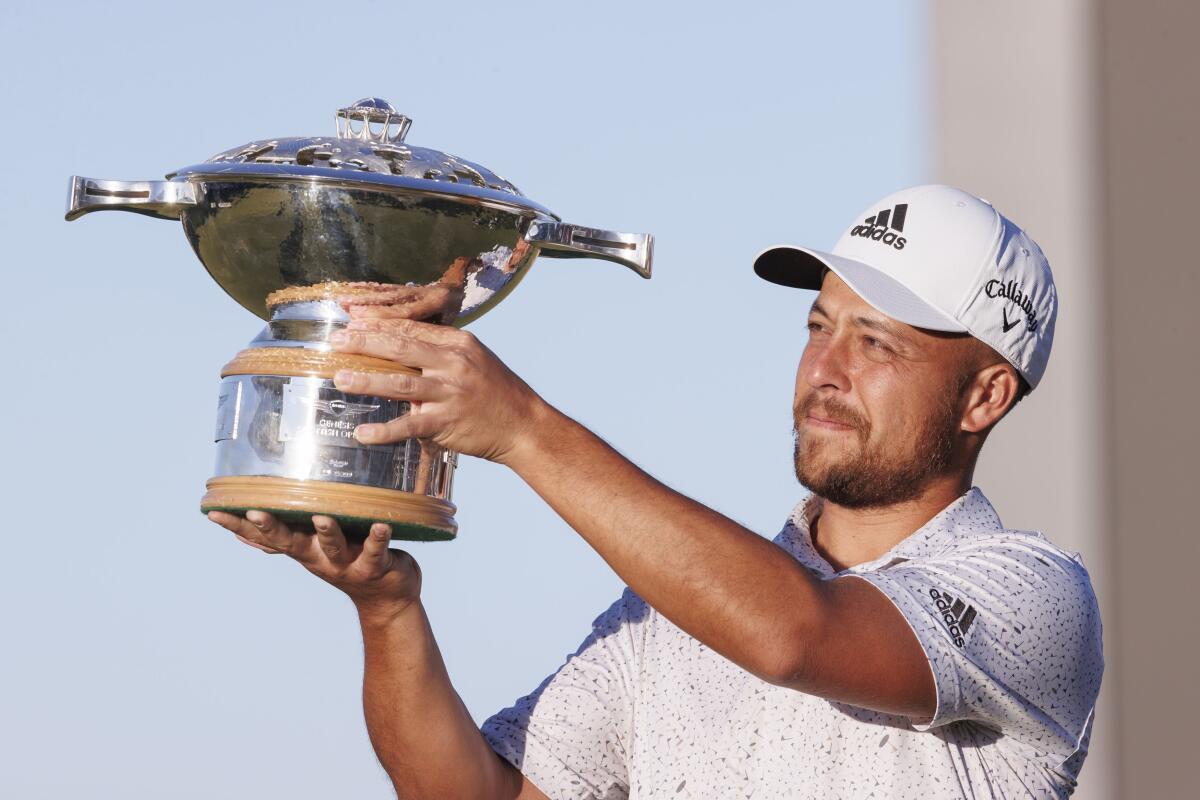 Xander Schauffele holds the trophy after winning the Genesis Scottish Open.