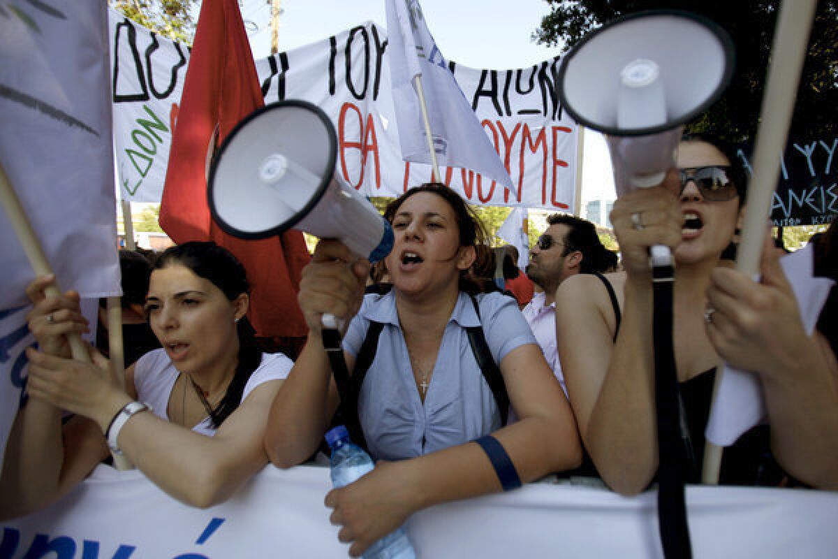 Protester shout slogans during an anti-bailout rally Tuesday outside parliament in Nicosia, the capital of Cyprus.