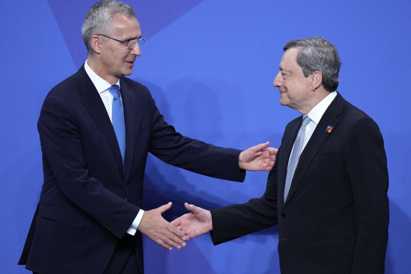 NATO Secretary General Jens Stoltenberg, left, shakes hands with Italian Prime Minister Mario Draghi at the official arrivals for the NATO summit in Madrid, Spain, on Wednesday, June 29, 2022. North Atlantic Treaty Organization heads of state will meet for a NATO summit in Madrid from Tuesday through Thursday. (AP Photo/Bernat Armangue)