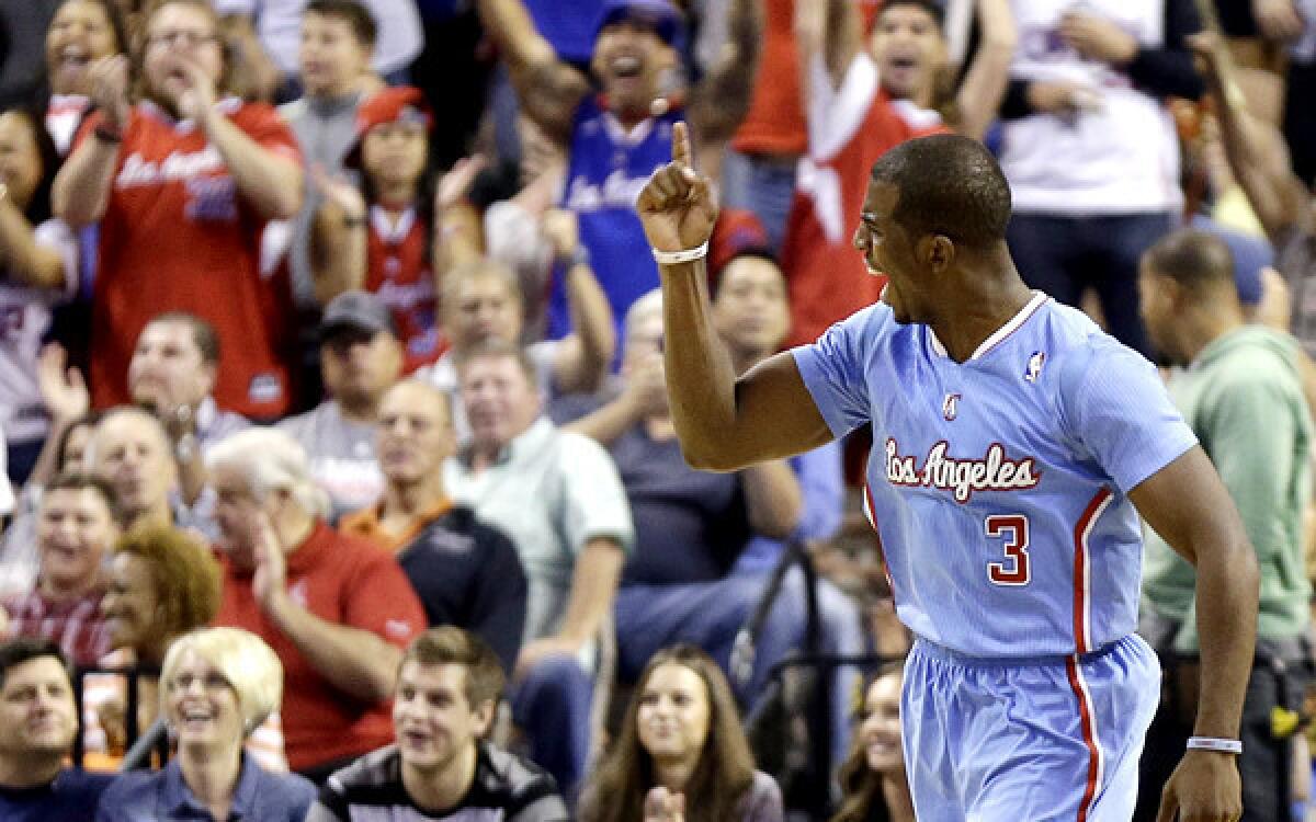 Clippers point guard Chris Paul celebrates a basket to tie the score against the Nuggets in the final seconds of a preseason game Saturday night.