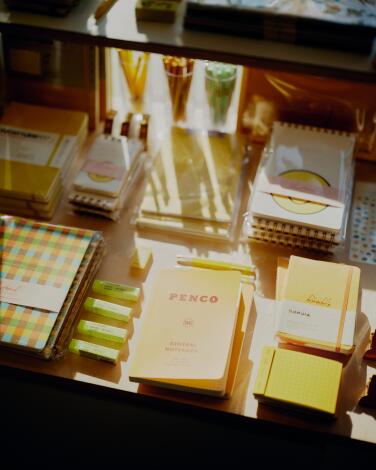 An assortment of yellow and beige stationery supplies at a store