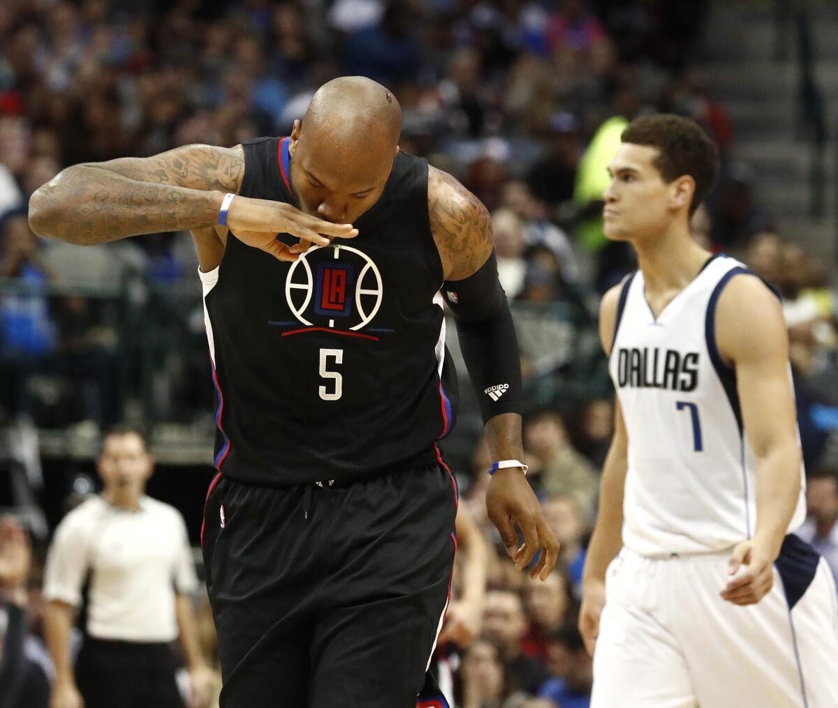 Clippers forward center Marreese Speights after making a three-pointer against the Mavericks in the first half.