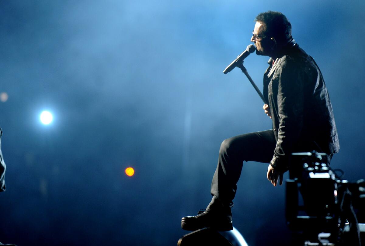 Bono performs with U2 at the Rose Bowl in 2009. The band has just released a new album that comes pre-loaded into iTunes.