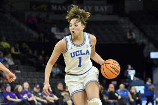 UCLA guard Kiki Rice handles the ball during a game against Arizona State