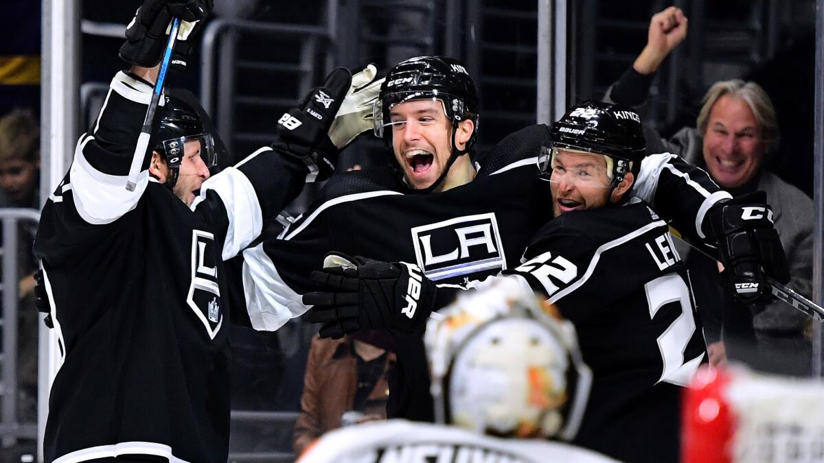 Kings rookie defenseman Kurtis MacDermid, center, celebrates with teammates Trevor Lewis, right, and Kyle Clifford after Lewis scored against the Flyers on Thursday.