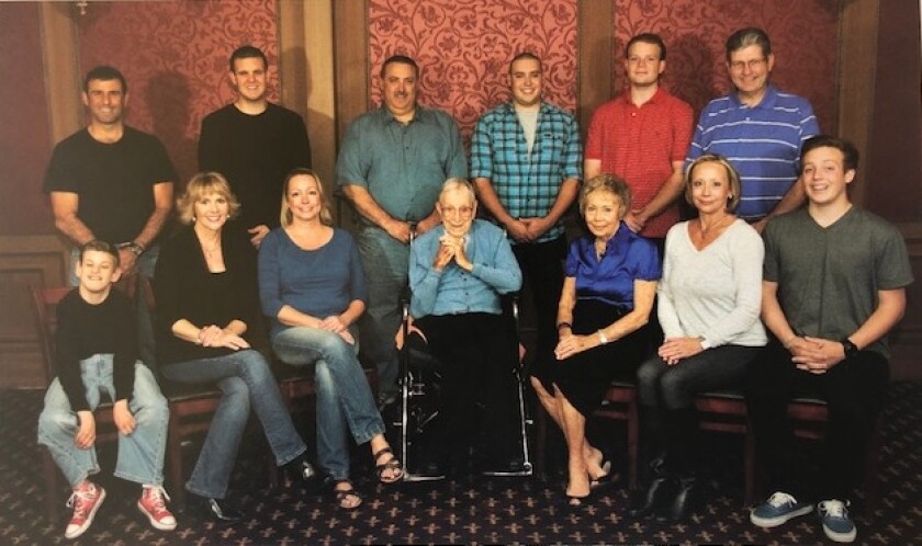 John Wooden, center, sits with his daugher, Nan, to his left, and her children, their spouses and children.