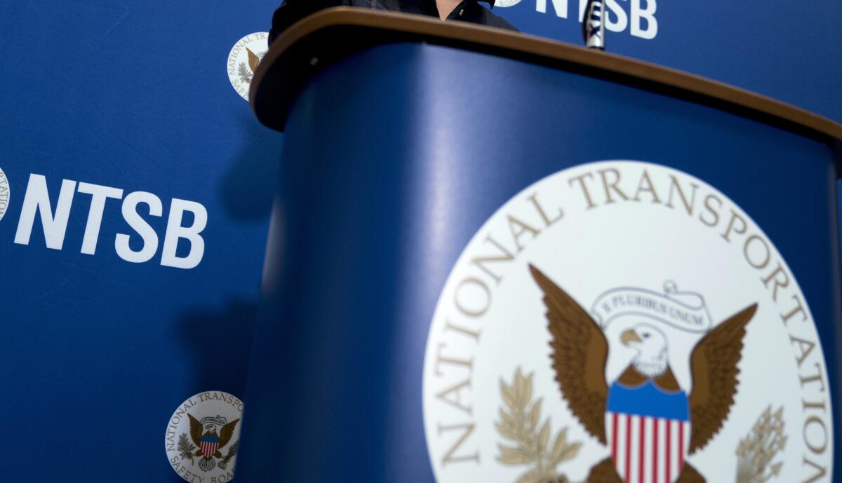 FILE - The National Transportation Safety Board logo and signage are seen at a news conference at NTSB headquarters in Washington, Dec. 18, 2017. On Friday, Sept. 9, 2022, the National Transportation Safety Board and the Federal Aviation Administration agreed that the NTSB will take the lead investigating accidents that involve death or serious injury or that create potentially deadly debris, while the FAA will handle other investigations. (AP Photo/Andrew Harnik, File)