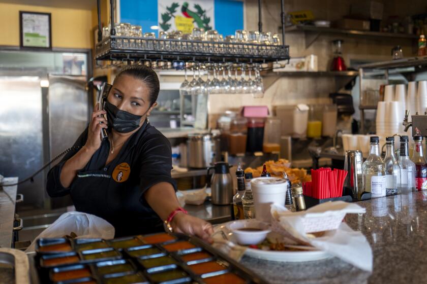 LOS ANGELES, CA - NOVEMBER 21: Paola Morataya, (CQ) 39, is working at Amalia's Restaurant on Sunday, Nov. 21, 2021 in Los Angeles, CA. On Nov. 29, many establishments like Amalia's will be required to demand proof of vaccination for several months. (Francine Orr / Los Angeles Times)
