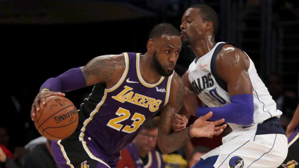 Lakers forward LeBron James drives to the basket against Mavericks forward Harrison Barnes.