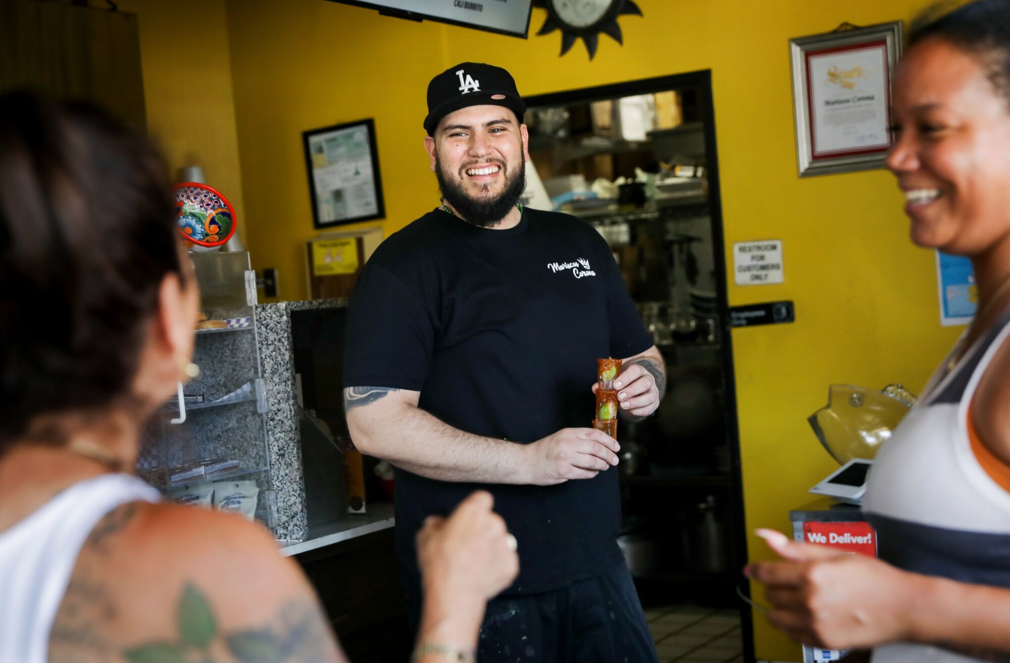 Joel Gonzalez chats with customers at Mariscos Corona
