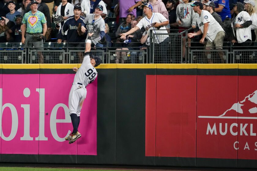New York Yankees right fielder Aaron Judge makes a catch at the fence on a long ball from Seattle Mariners' Teoscar Hernandez during the eighth inning of a baseball game Monday, May 29, 2023, in Seattle. (AP Photo/Lindsey Wasson)