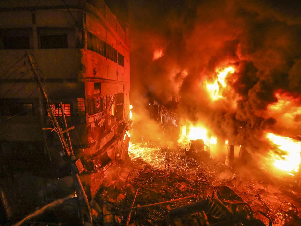 Flames rise from a fire in a densely packed district of Dhaka, Bangladesh. The blaze raced through at least five buildings in an old part of the capital, killing scores.