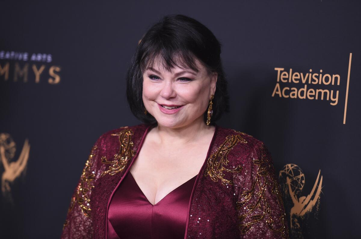 Delta Burke smiles in burgundy and gold at the Creative Arts Emmy Awards