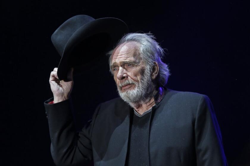 Merle Haggard tips his hat to the crowd as he begins to perform on the Palomino Stage on the first night of the sold-out three-day Stagecoach Country Music Festival at the Empire Polo Club in Indio on Friday.